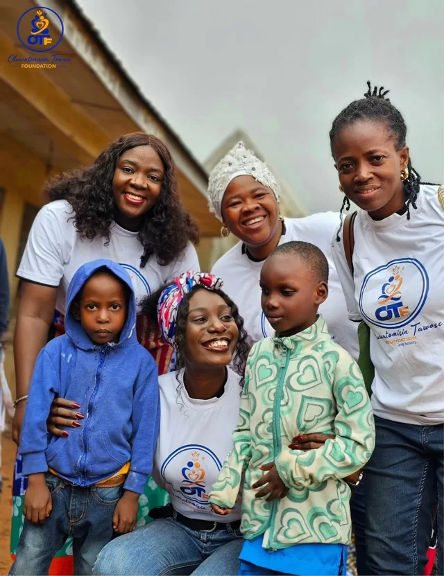 Volunteers and children sharing a moment together.